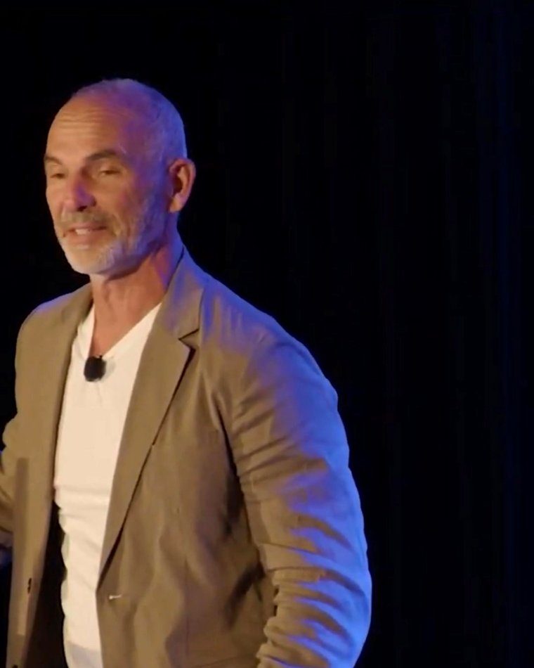 Dr. Jack Wolfson teaching on stage